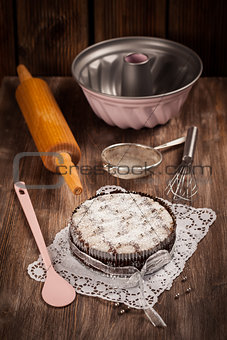 White and chocolate Christmas cake with baking utensils