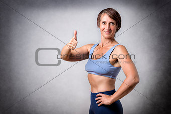Middle aged woman with thumb up