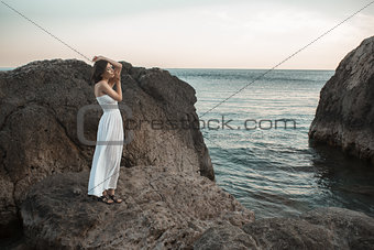 Woman relaxing at the beach with arms open