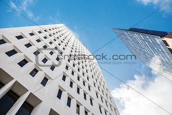 Fragment of a glass skyscraper merged with blue sky. skylines in down town