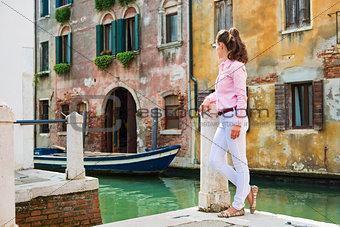 Woman tourist taking a break by one of Venice's canals