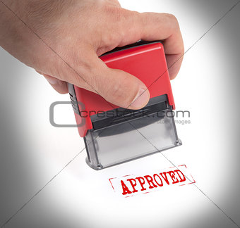 Plastic stamp in hand, isolated