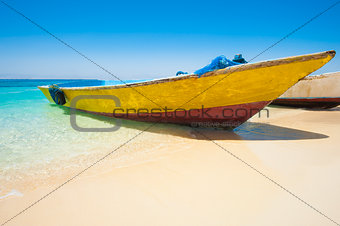 Traditional wooden boat on a tropical beach