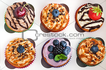 Set of different delicious cupcakes in box