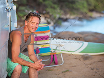 Happy Surfer Sitting at Beach