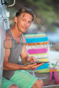 Man on Vacation with Tablet Computer