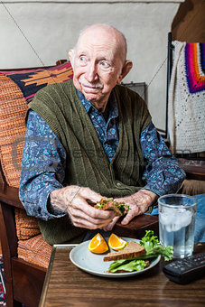 Elderly Man Holding Sandwich