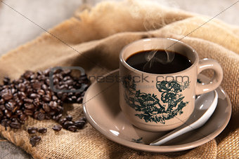 Traditional oriental Hainan coffee in vintage mug