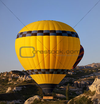 Hot air balloons in mountains at early morning