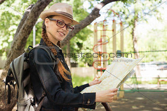 woman holding a map in the park