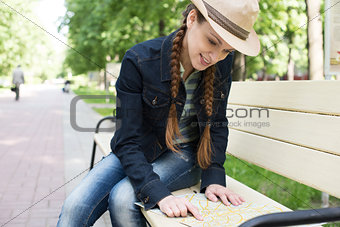 woman holding a map in the park