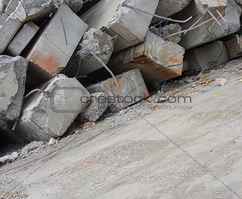 large concrete chunks with twisted metal on a demolition site 