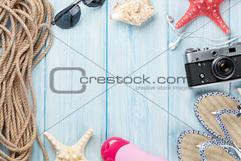 Travel and vacation items on wooden table