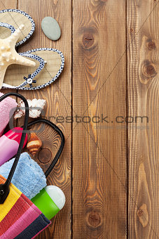 Travel and vacation items on wooden table