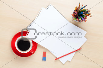 Office desk table with supplies and coffee cup