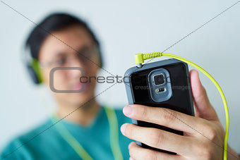 Chinese Man With Green Headphones Listens Music Podcast Phone