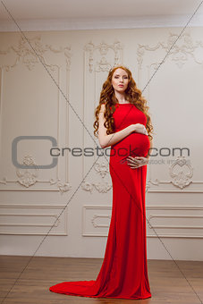 Pregnant fashion model in red dress