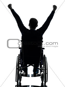 rear view handicapped man arms raised  in wheelchair silhouette