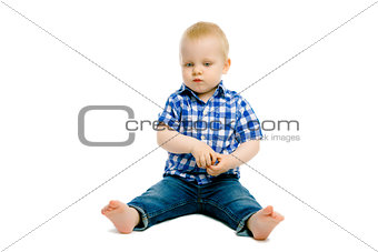boy sitting on a white floor