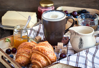 Breakfast with croissants, cappuccino and jam 