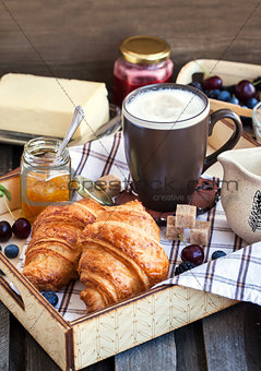Breakfast with croissants, cappuccino and jam 