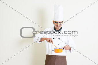 Indian male chef in uniform preparing food