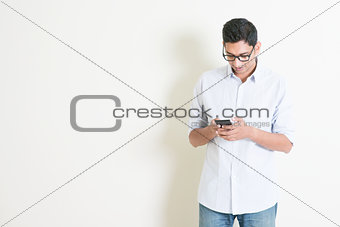 Casual business Indian male using smartphone