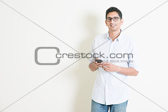 Casual business Indian male using mobile apps