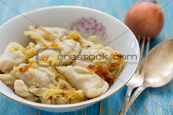Dumplings with potatoes and fried onions.