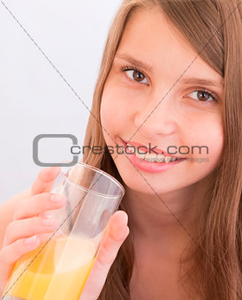 Teenage girls drinking orange juice