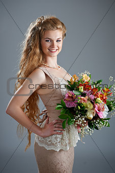 Pretty woman in dress with bouquet of flowers