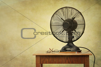 Old electric fan on table with retro look