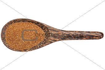 teff grain on wooden spoon
