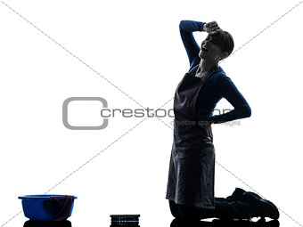 woman maid housework tired backache washing floor silhouette