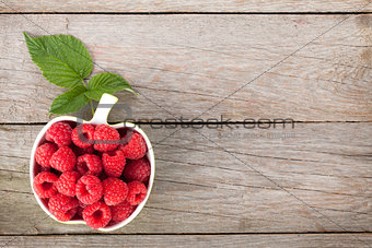 Fresh ripe raspberries on wooden table