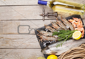 Fresh raw sea food with spices and white wine