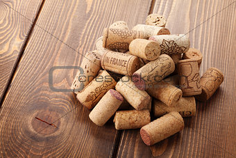 Wine corks heap over rustic wooden table background