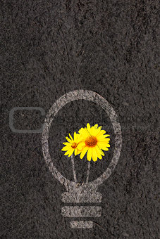 Eco background with soil and light bulb silhouette 