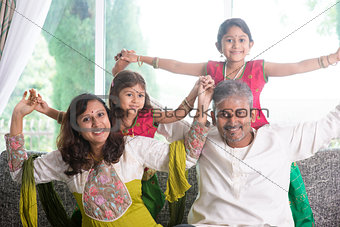 Happy Indian family playing at home