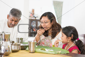 Indian family eating banana leaf rice
