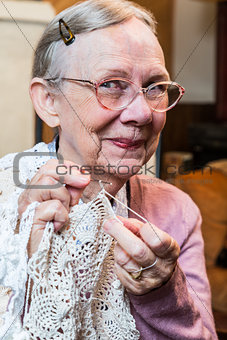 Smiling Elderly Woman with Crochet