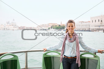 Happy woman tourist relaxing on a boat in Venice