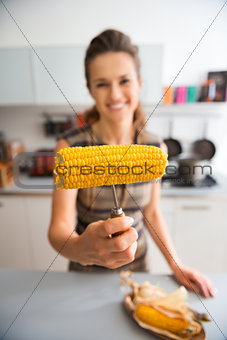 Closeup of corncob held by anonymous woman's hand