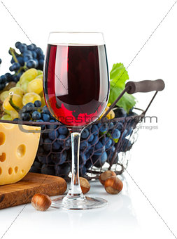Glass red wine with grapes and cheese