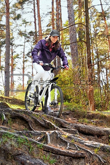 Bike riding - woman on bike in forest