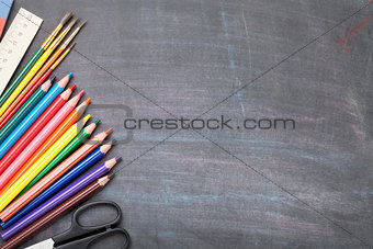 School supplies on blackboard background