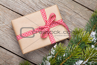 Christmas fir tree with snow and gift box