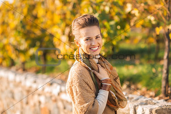 Portrait of happy elegant brunette woman in autumn outdoors