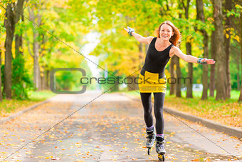 slender red-haired girl on roller skates rolling