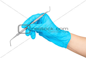 gloved hand holding a metal dental instruments plugger - trowel 